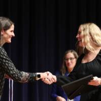 jenn handing the cord at stage